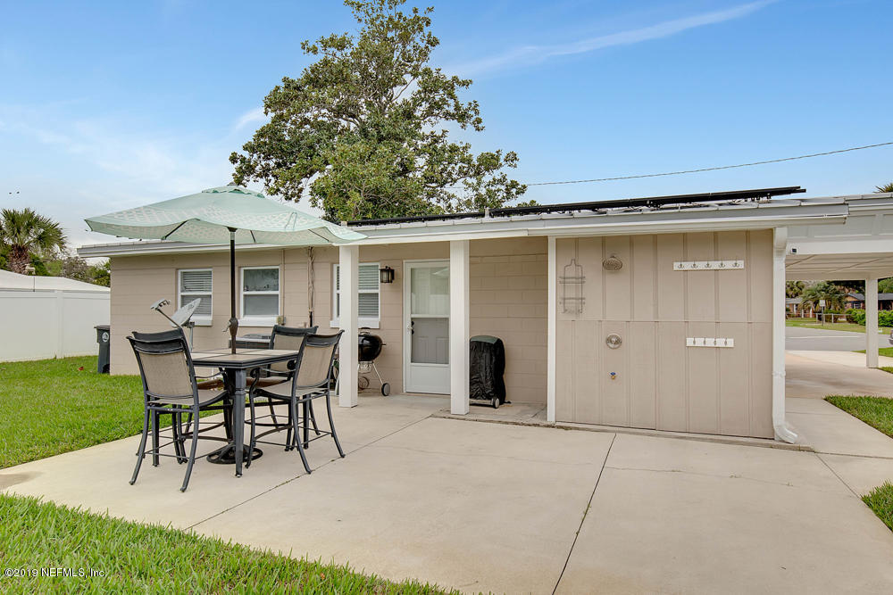 760 Triton Road Atlantic Beach, FL 32233 - Photo 20 of 24 a patio with a table and chairs and potted plants