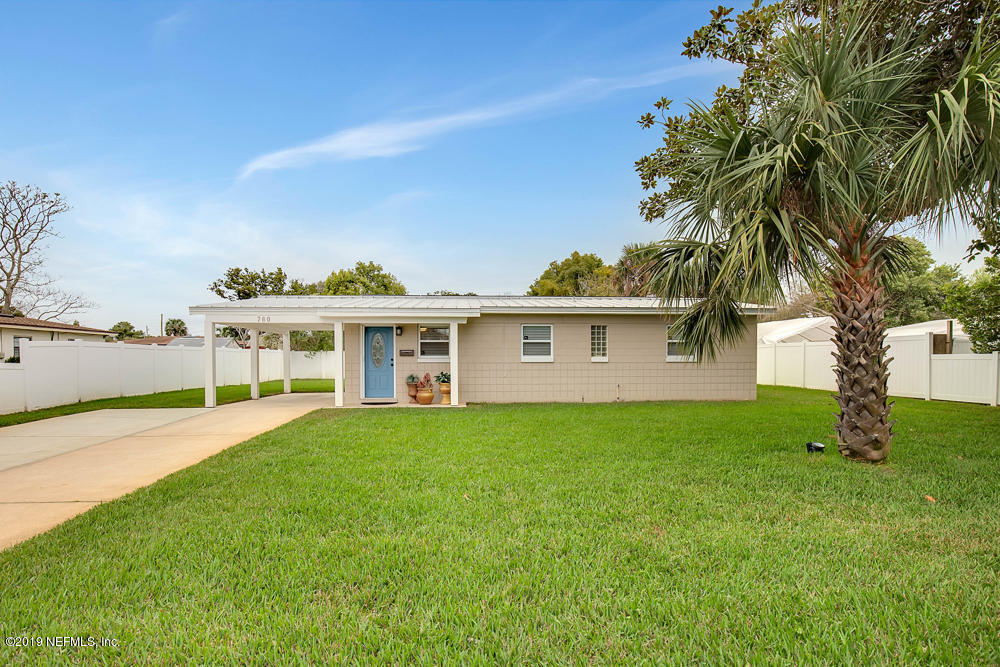 760 Triton Road Atlantic Beach, FL 32233 - Photo 2 of 24 a front view of a house with garden