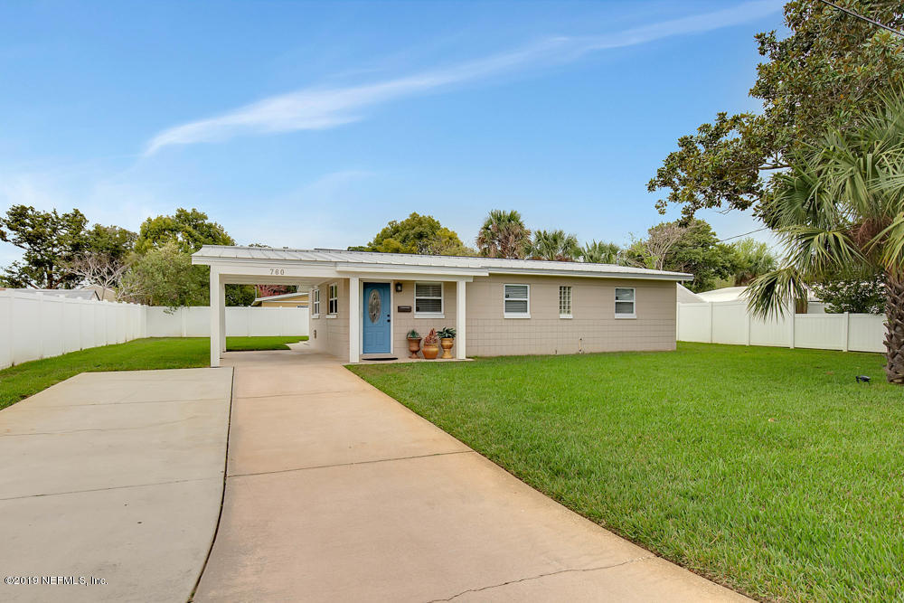 760 Triton Road Atlantic Beach, FL 32233 - Photo 3 of 24 a view of a white house with a big yard and potted plants