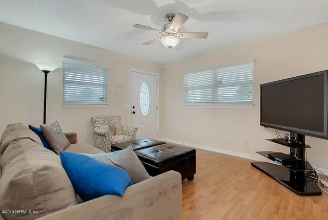 a living room with furniture and a flat screen tv