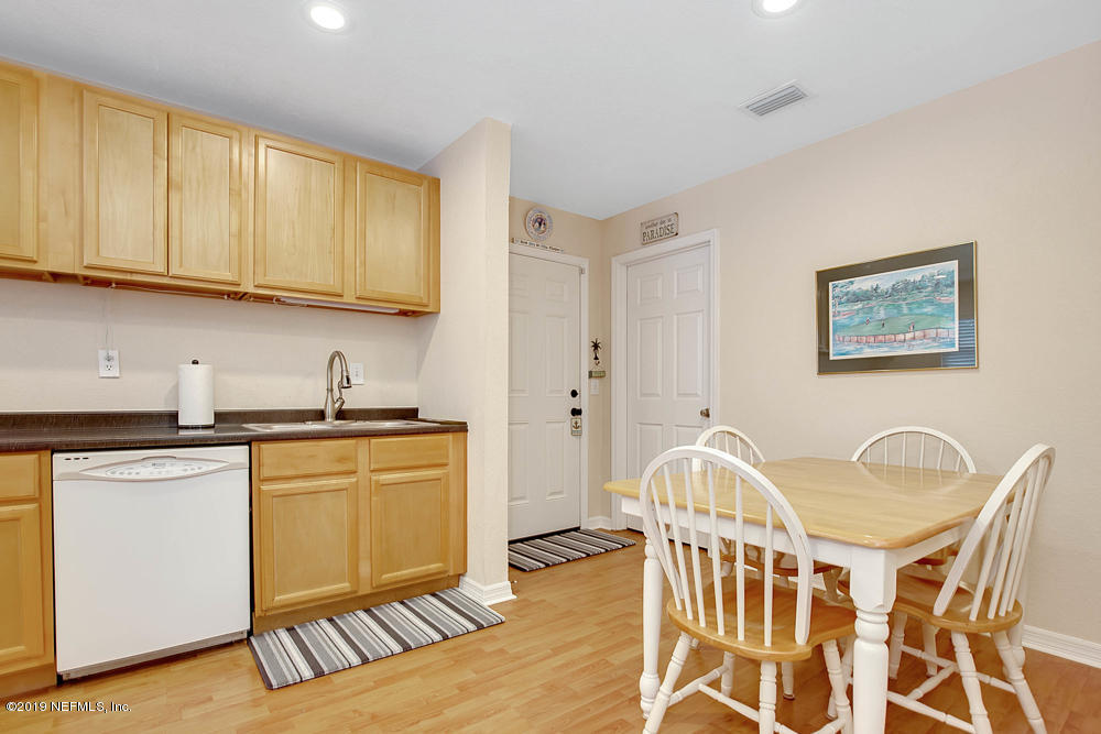 760 Triton Road Atlantic Beach, FL 32233 - Photo 9 of 24 a kitchen with stainless steel appliances granite countertop a stove a sink dishwasher and a microwave with wooden floor