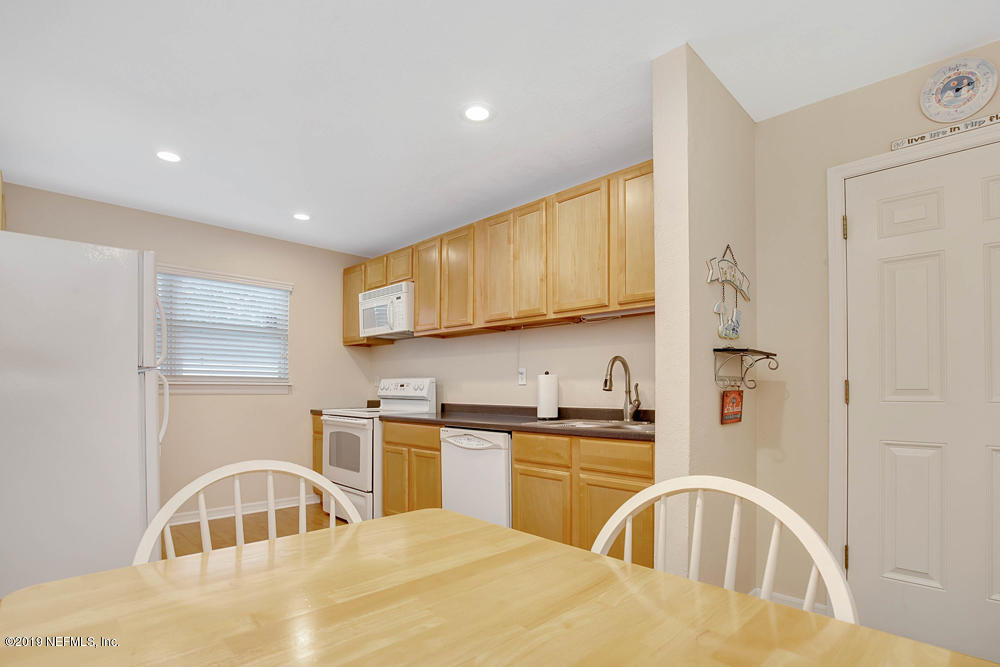 760 Triton Road Atlantic Beach, FL 32233 - Photo 10 of 24 a kitchen with stainless steel appliances granite countertop a sink a stove and a refrigerator