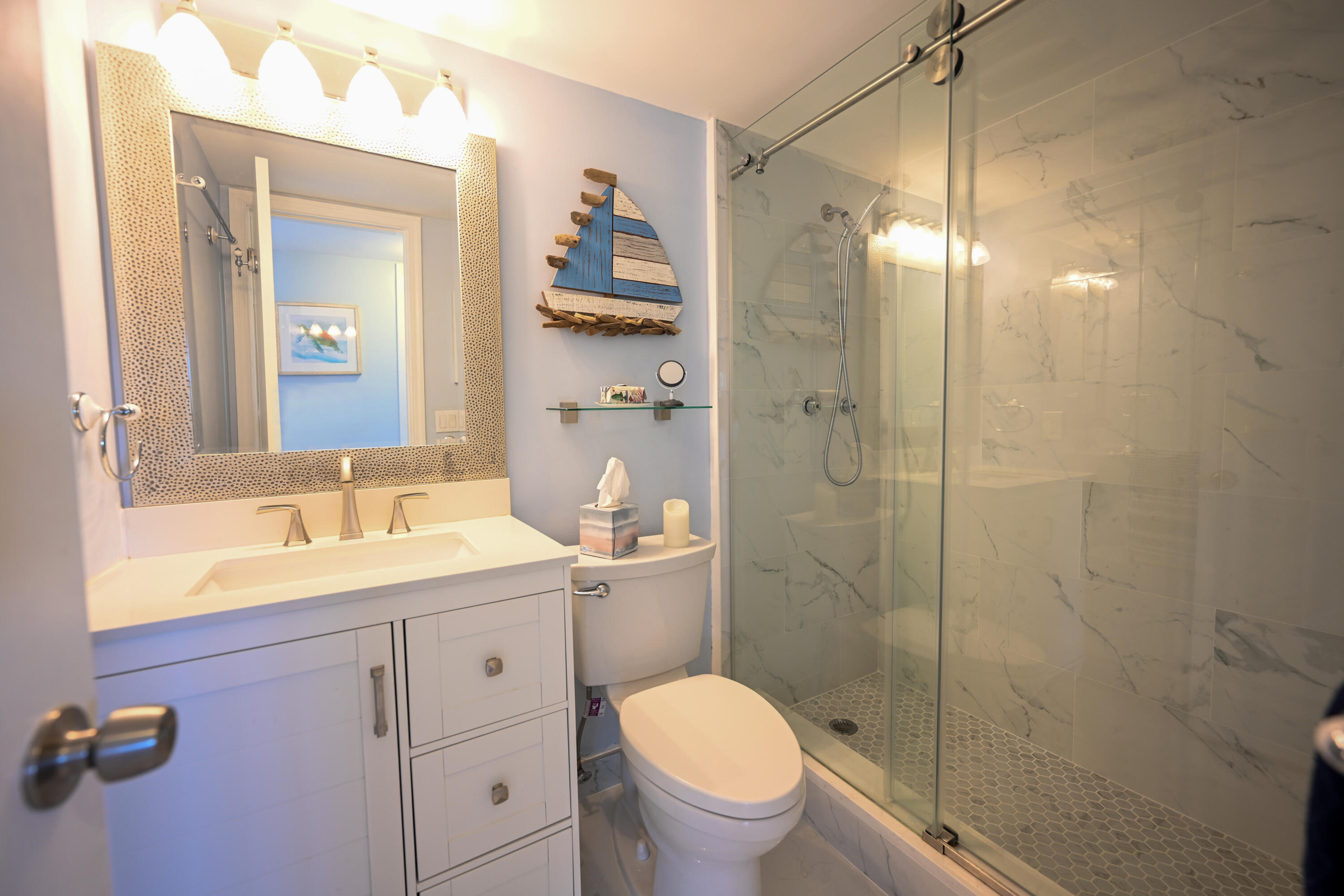 1700 South Ocean Boulevard, Unit 14 Delray Beach, FL 33483 - Photo 14 of 32 a bathroom with a granite countertop sink toilet a mirror a vanity and shower