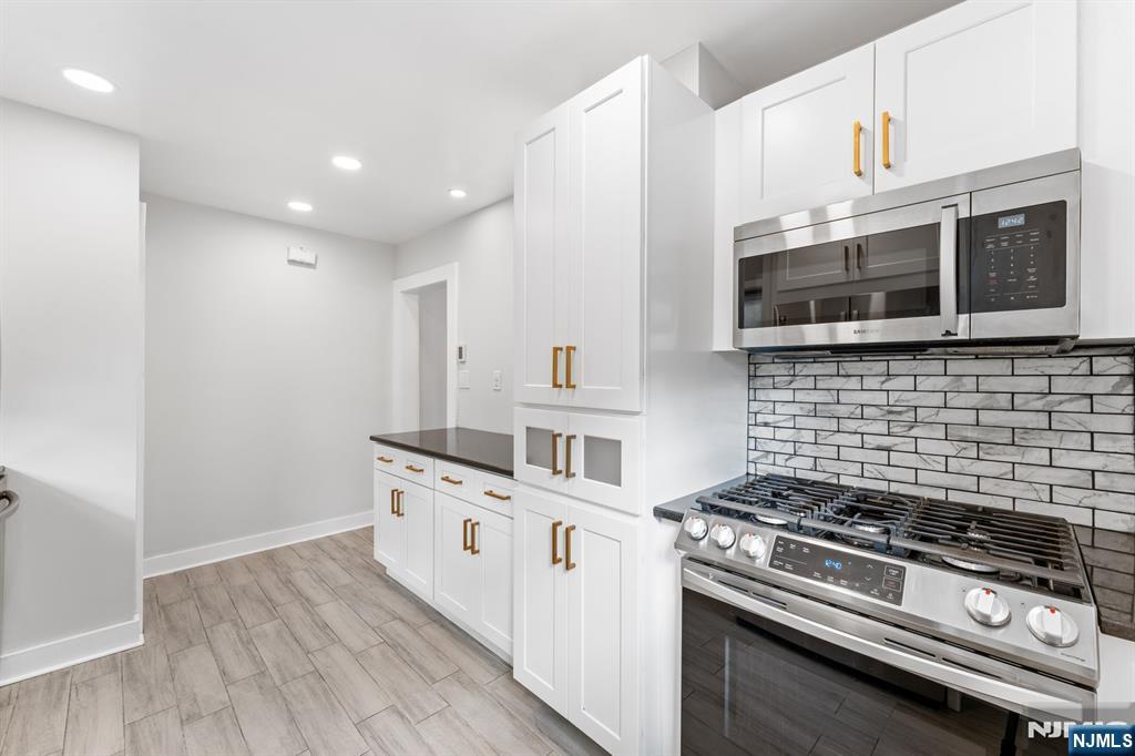 177 East Pierrepont Avenue Rutherford, NJ 07070 - Photo 16 of 27 a kitchen with stainless steel appliances granite countertop a stove and a microwave