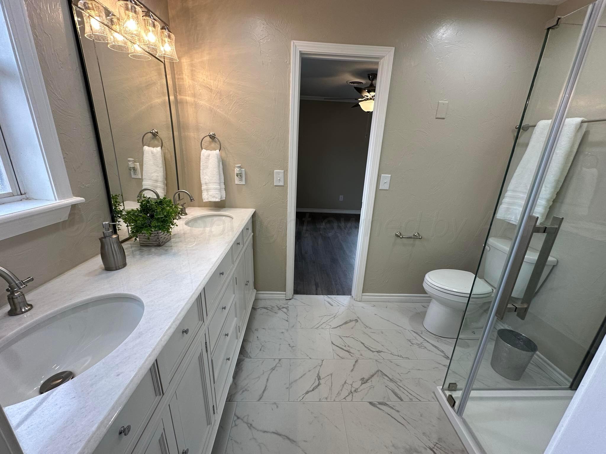 4402 Gary Lane Amarillo, TX 79110 - Photo 13 of 19 a spacious bathroom with a granite countertop sink a toilet and a tub