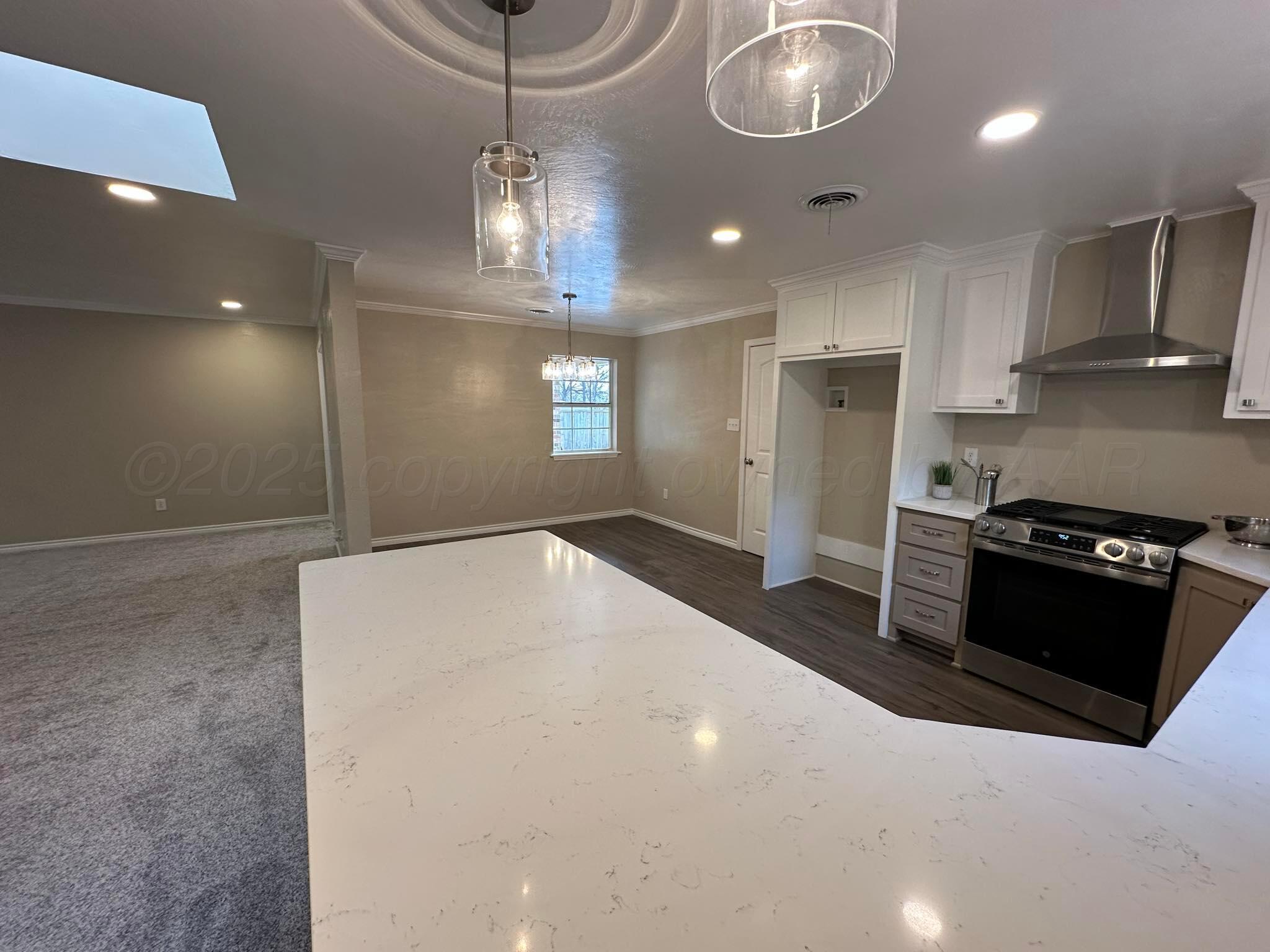 4402 Gary Lane Amarillo, TX 79110 - Photo 5 of 19 a kitchen with stainless steel appliances a refrigerator and a stove