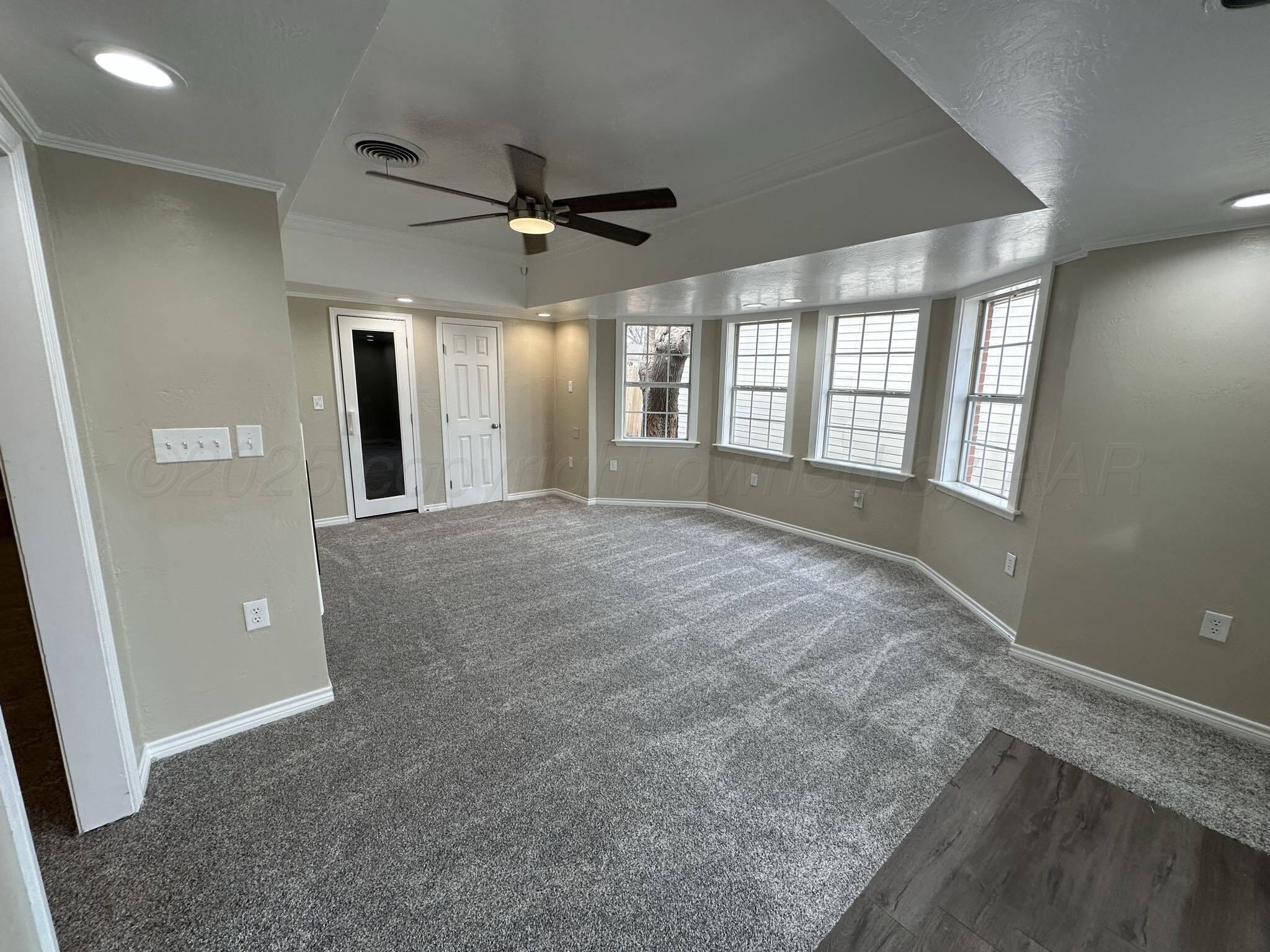 4402 Gary Lane Amarillo, TX 79110 - Photo 7 of 19 a view of a livingroom with a ceiling fan and window