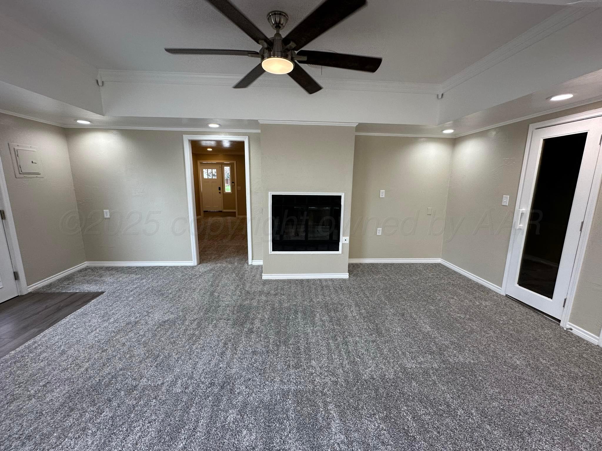 4402 Gary Lane Amarillo, TX 79110 - Photo 9 of 19 a view of a livingroom with a fireplace and a ceiling fan