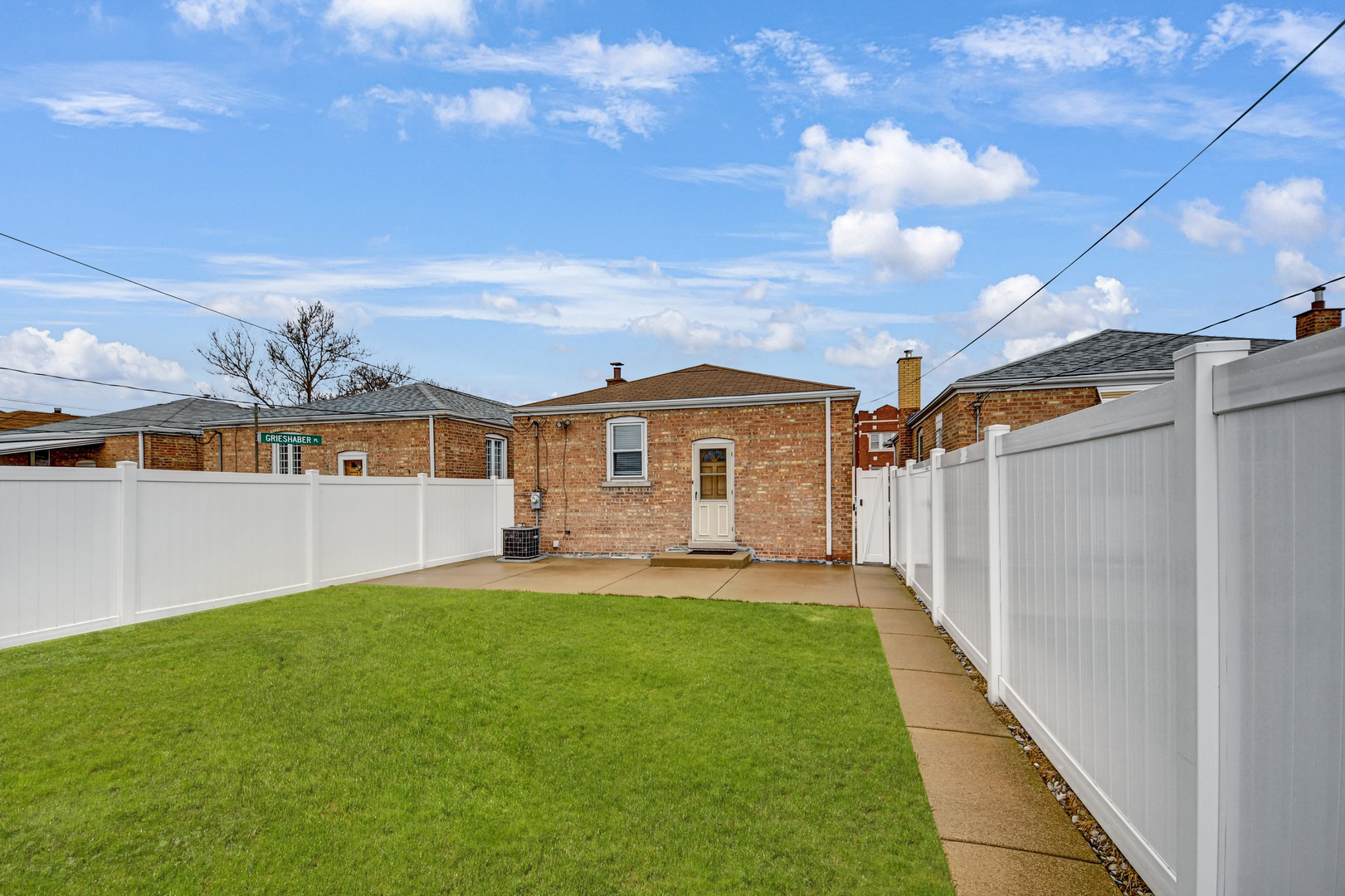 5927 West 64th Place Chicago, IL 60638 - Photo 20 of 23 a front view of a house with a yard and garage