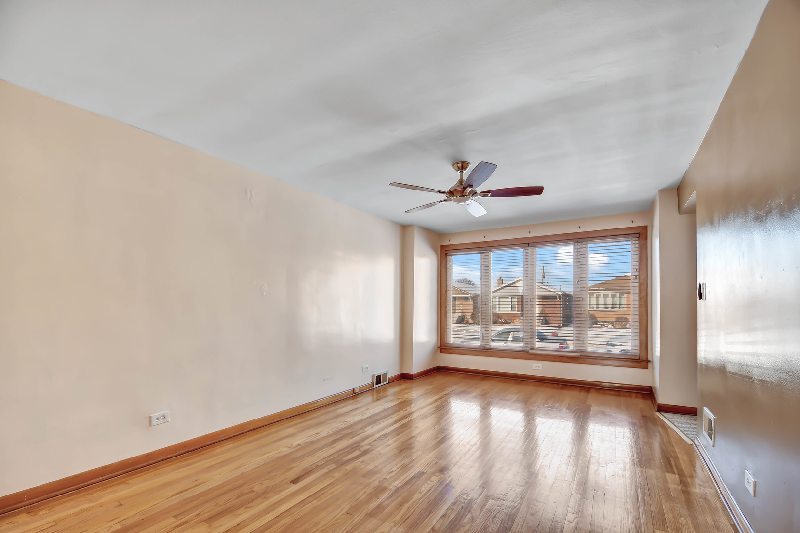 5927 West 64th Place Chicago, IL 60638 - Photo 2 of 23 an empty room with wooden floor fan and windows