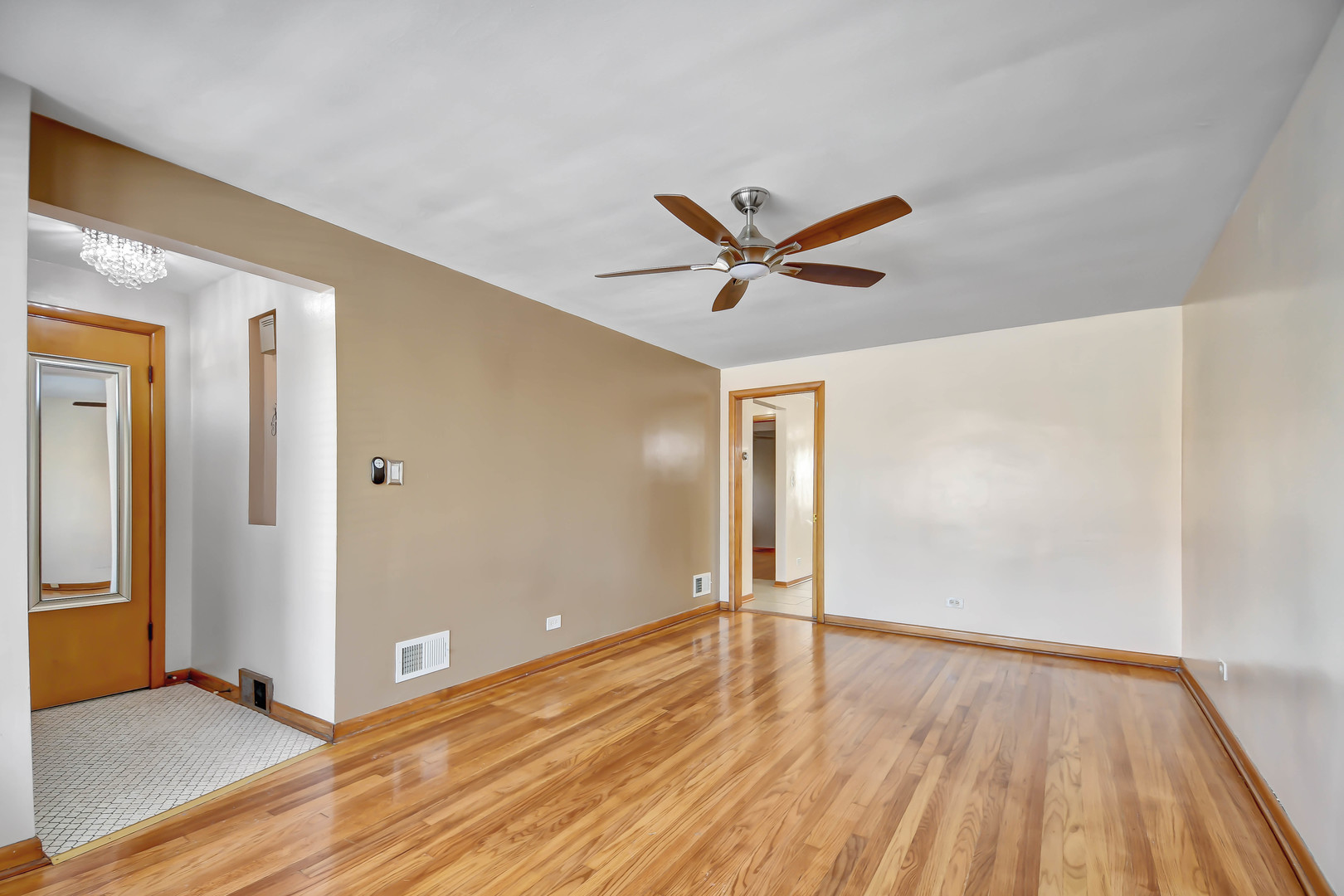 5927 West 64th Place Chicago, IL 60638 - Photo 3 of 23 a view of a big room with wooden floor and windows