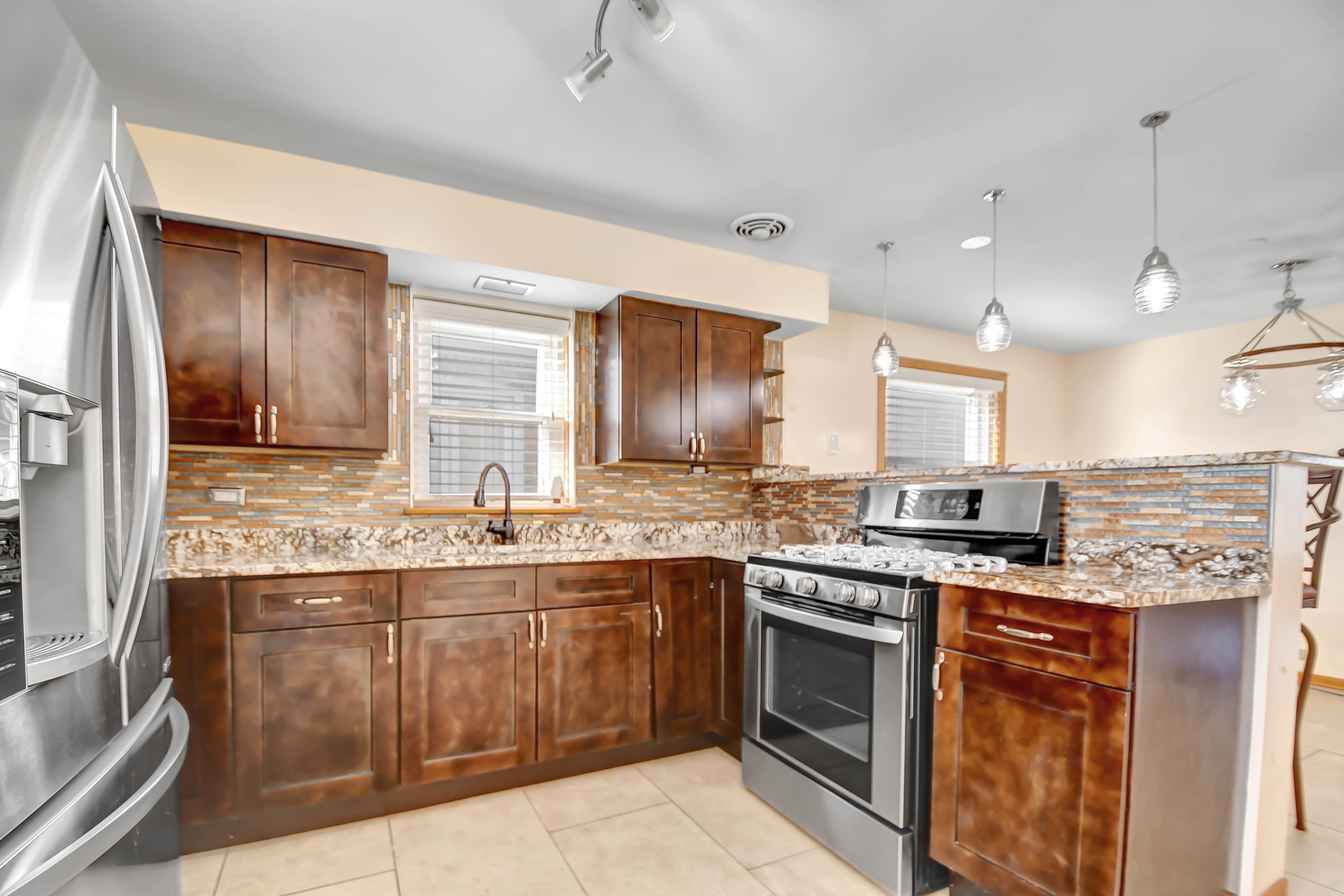 5927 West 64th Place Chicago, IL 60638 - Photo 8 of 23 a kitchen with stainless steel appliances granite countertop a stove and a sink