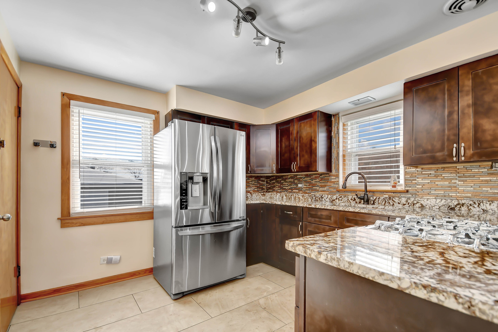 5927 West 64th Place Chicago, IL 60638 - Photo 9 of 23 a kitchen with stainless steel appliances granite countertop a refrigerator and a stove