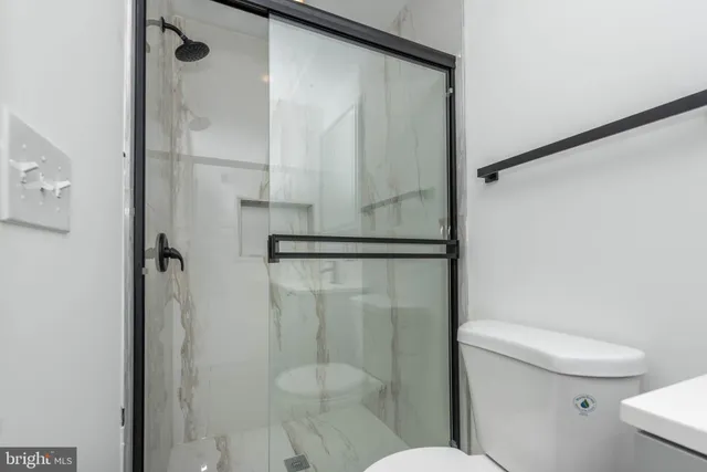 a white toilet sitting next to a bathroom sink