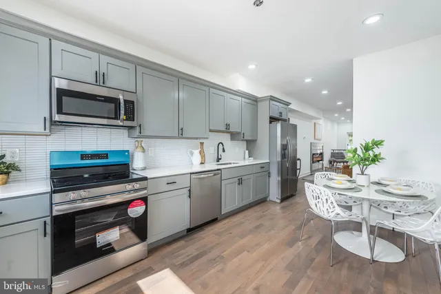 a kitchen with a sink cabinets and stainless steel appliances