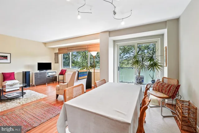 a dining room with furniture and wooden floor