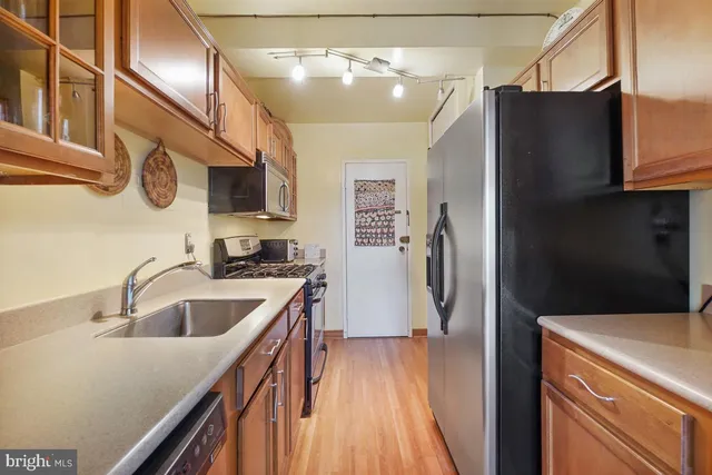 a kitchen with stainless steel appliances granite countertop a stove and a microwave