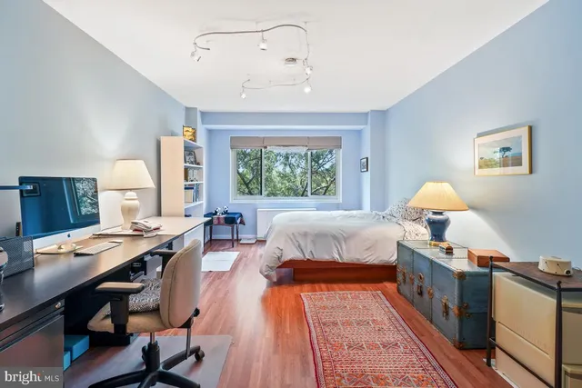 a bedroom with a bed and a book shelf