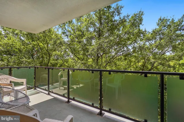a view of a chairs and table in the balcony