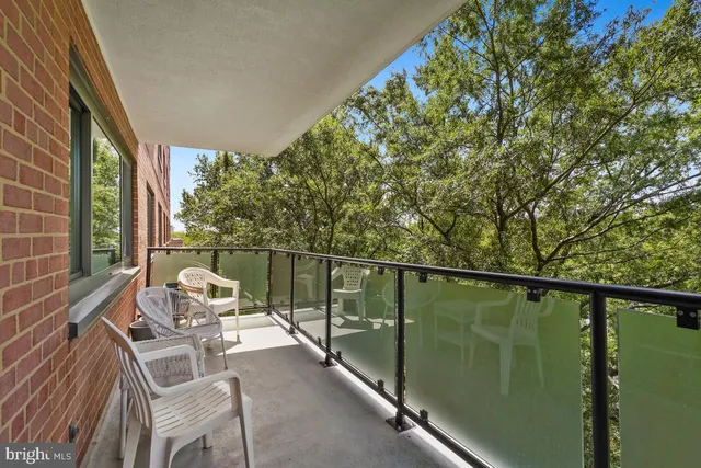 an aerial view of residential house with outdoor space and trees all around