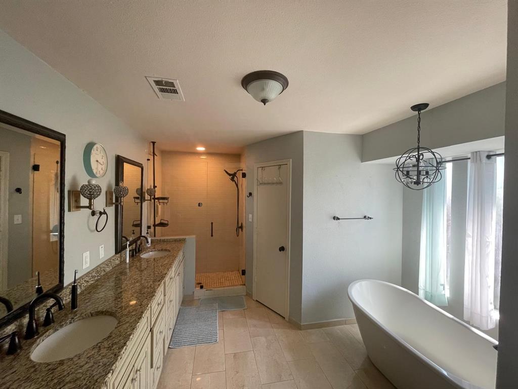 3612 Cross Bend Road Plano, TX 75023 - Photo 30 of 38 Bathroom featuring tiled shower, a notable chandelier, dual vanity, and tile flooring