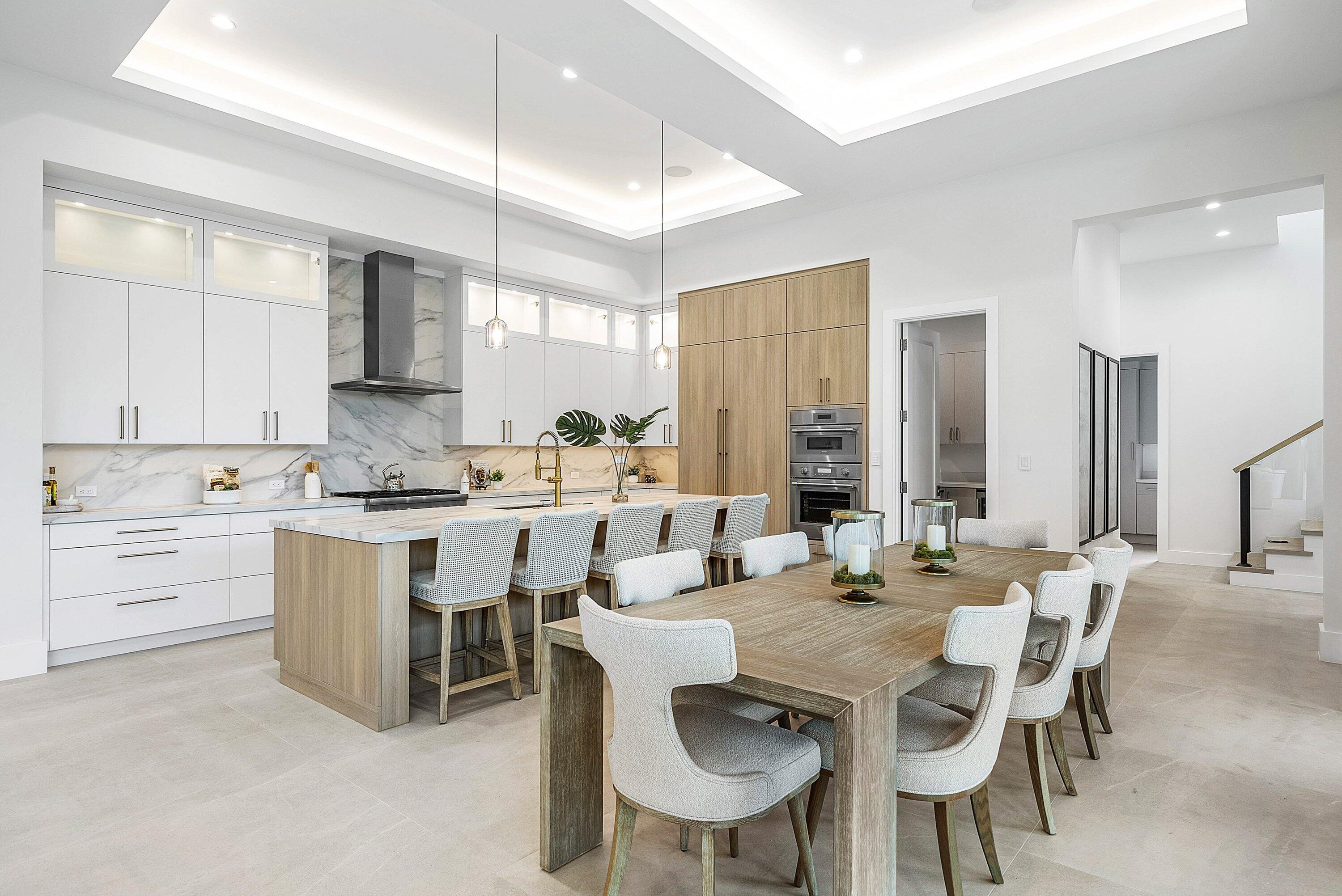 2609 Northeast 27th Way Fort Lauderdale, FL 33306 - Photo 13 of 53 a kitchen with a dining table chairs sink and cabinets