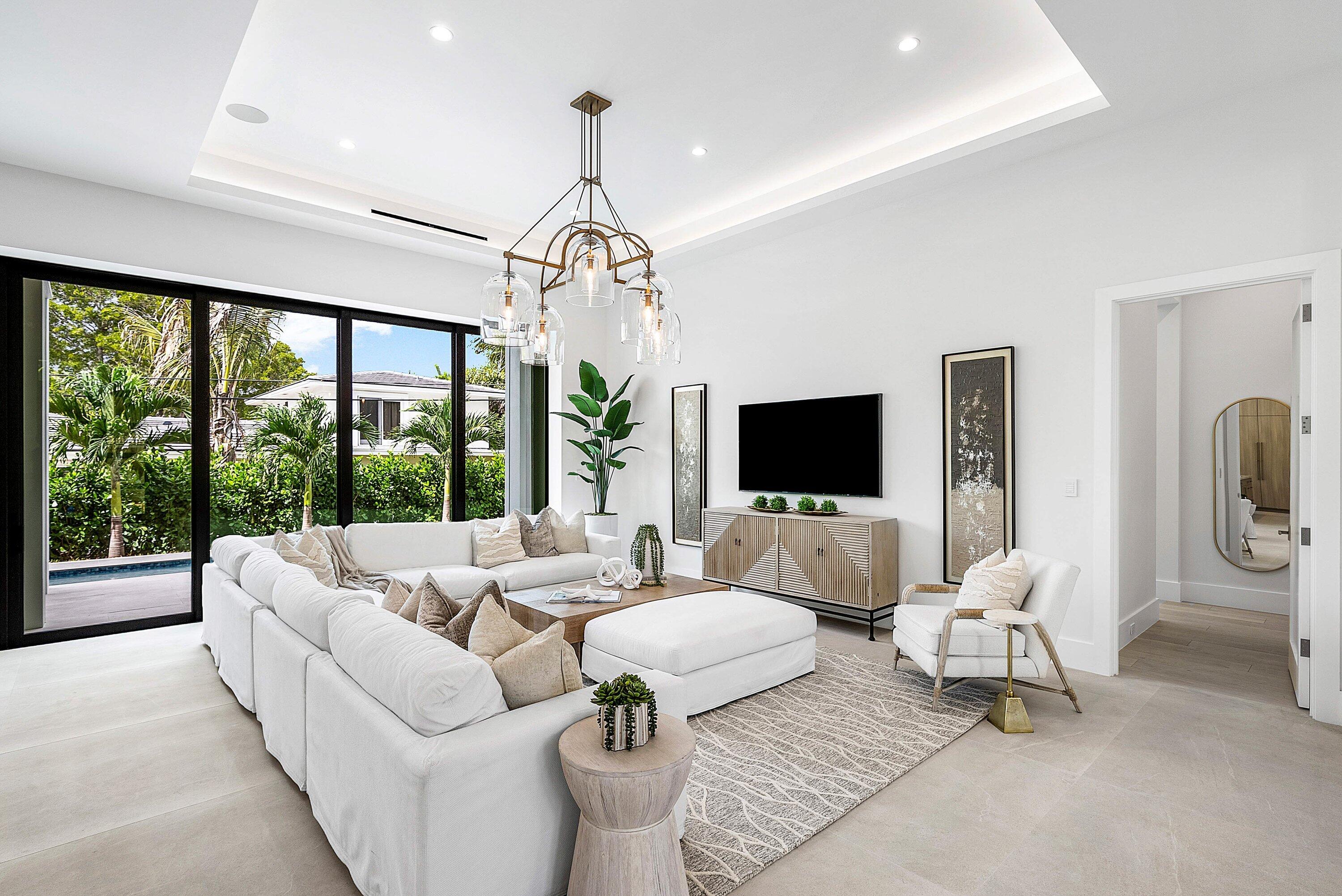 2609 Northeast 27th Way Fort Lauderdale, FL 33306 - Photo 7 of 53 a living room with furniture and a chandelier