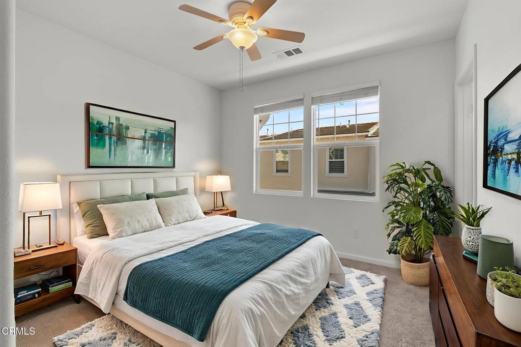 3705 Islander Walk Oxnard, CA 93035 - Photo 27 of 45 a bedroom with a large bed and a potted plant
