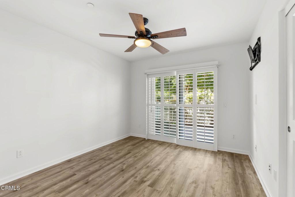3705 Islander Walk Oxnard, CA 93035 - Photo 31 of 45 an empty room with wooden floor fan and windows