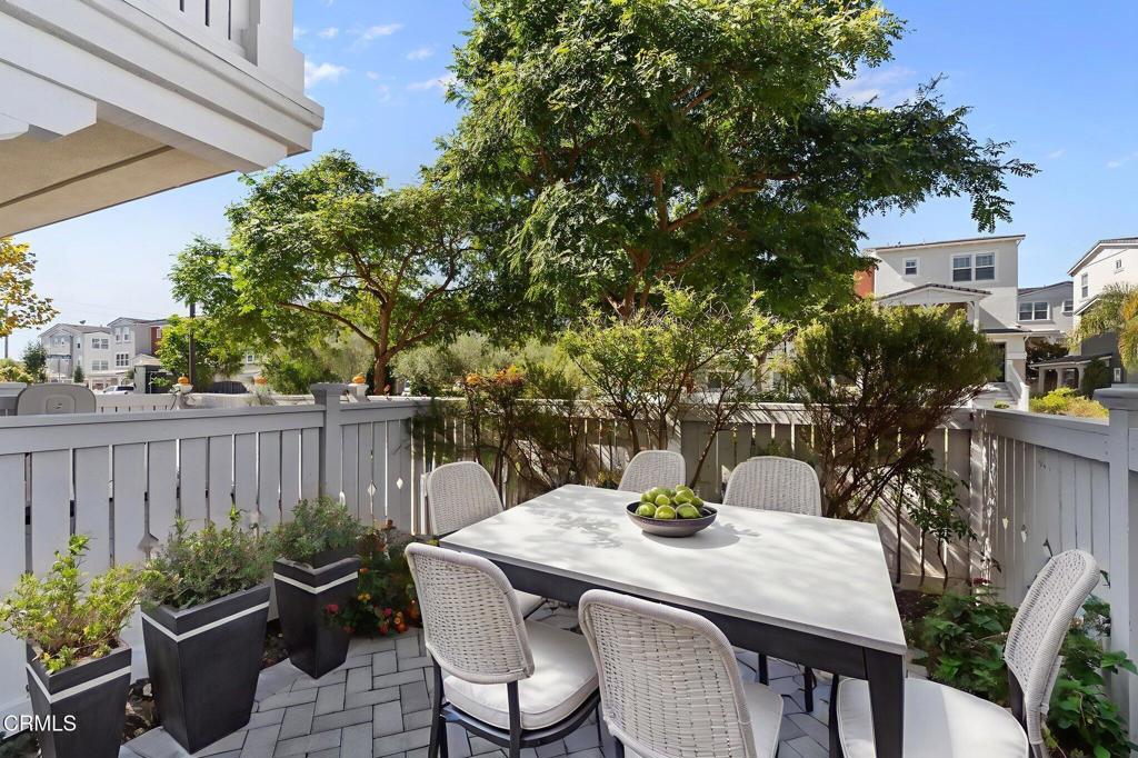 3705 Islander Walk Oxnard, CA 93035 - Photo 34 of 45 a view of a patio with table and chairs potted plants and tree