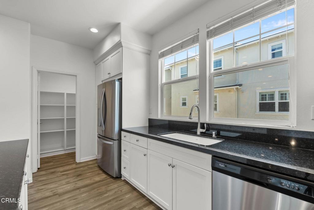 3705 Islander Walk Oxnard, CA 93035 - Photo 10 of 45 a kitchen with stainless steel appliances granite countertop a sink and a refrigerator