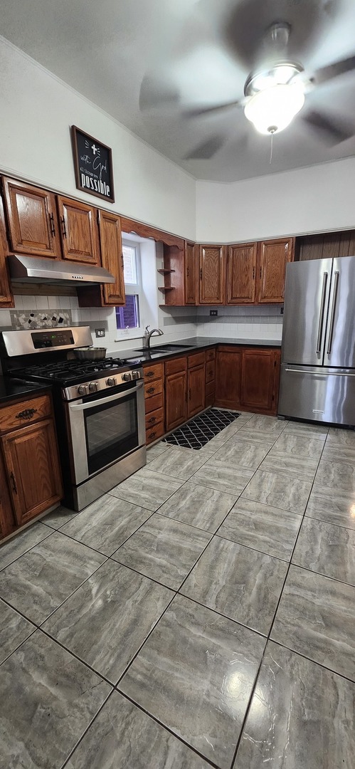 4450 West Altgeld Street, Unit 1 Chicago, IL 60639 - Photo 13 of 29 a kitchen with stainless steel appliances granite countertop a stove a sink and a refrigerator