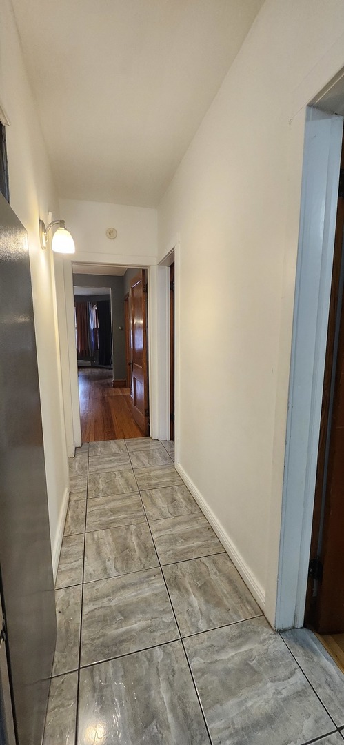 4450 West Altgeld Street, Unit 1 Chicago, IL 60639 - Photo 14 of 29 a view of a hallway view with wooden floor and a living room