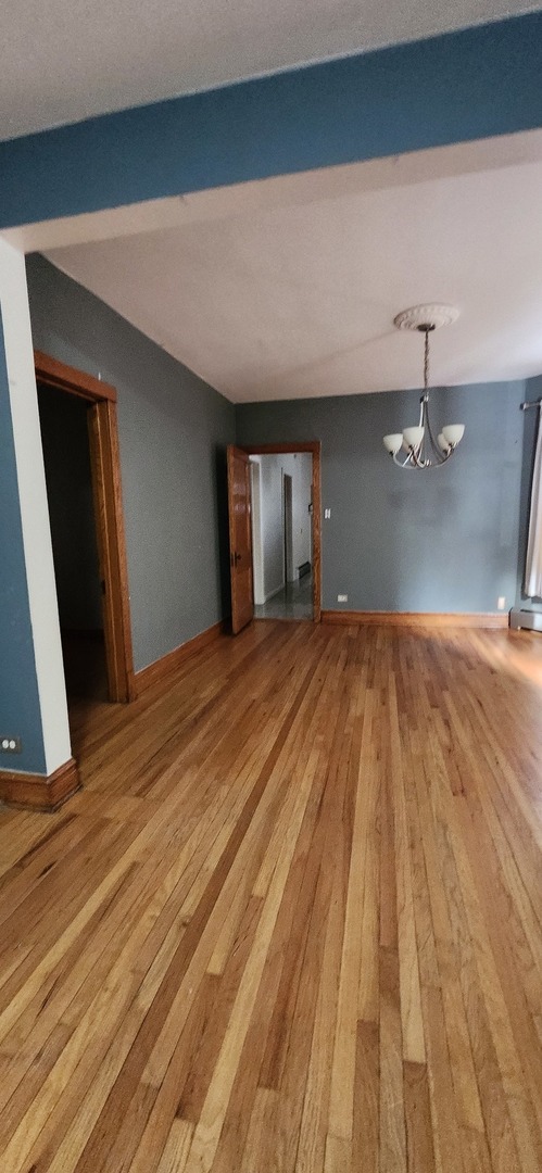 4450 West Altgeld Street, Unit 1 Chicago, IL 60639 - Photo 17 of 29 a bedroom with a bed and a dresser