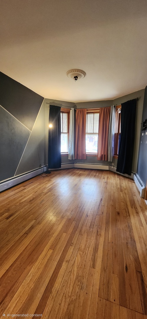 4450 West Altgeld Street, Unit 1 Chicago, IL 60639 - Photo 2 of 29 an empty room with wooden floor and windows