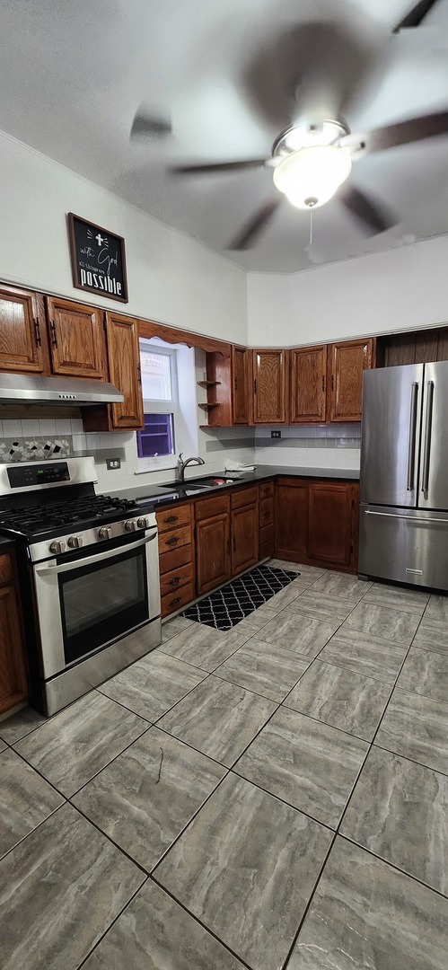 4450 West Altgeld Street, Unit 1 Chicago, IL 60639 - Photo 22 of 29 a kitchen with stainless steel appliances granite countertop a stove a sink dishwasher and a refrigerator