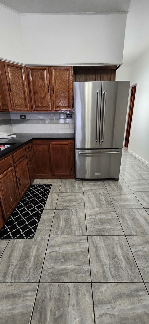 4450 West Altgeld Street, Unit 1 Chicago, IL 60639 - Photo 23 of 29 a kitchen with granite countertop a refrigerator and a stove top oven