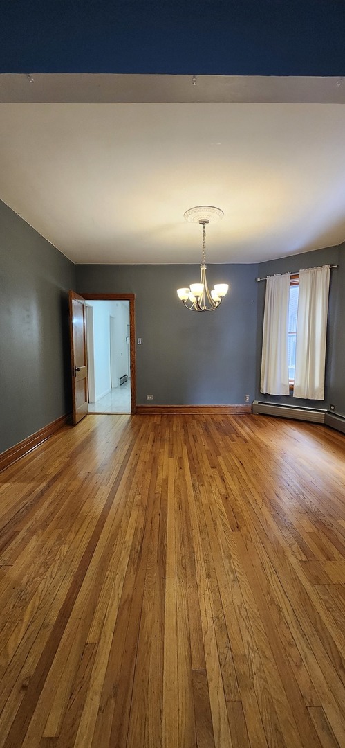 4450 West Altgeld Street, Unit 1 Chicago, IL 60639 - Photo 27 of 29 a view of empty room with wooden floor