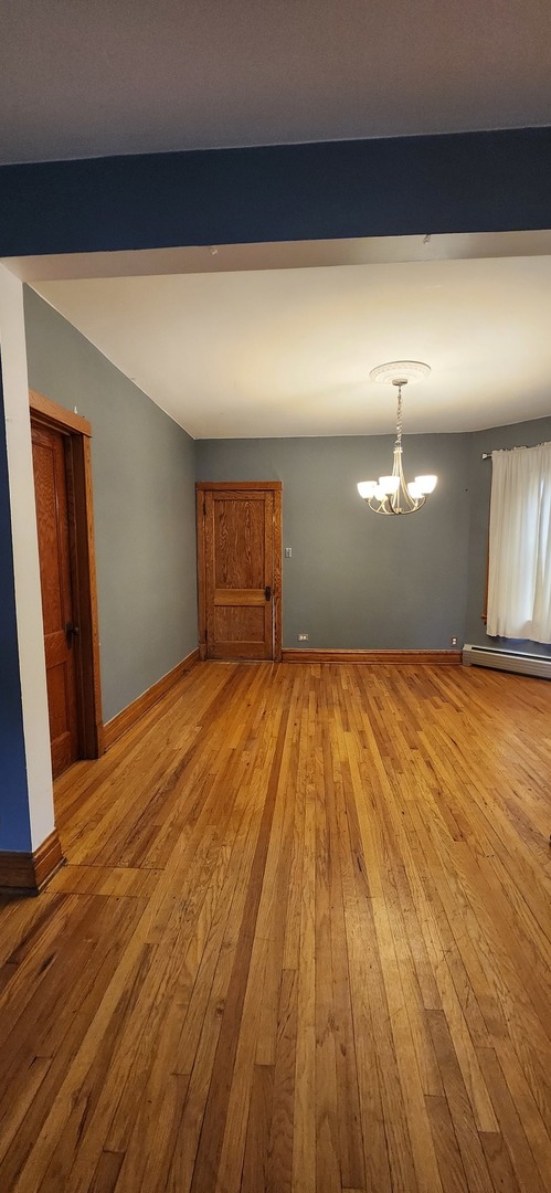 4450 West Altgeld Street, Unit 1 Chicago, IL 60639 - Photo 5 of 29 a view of empty room with wooden floor