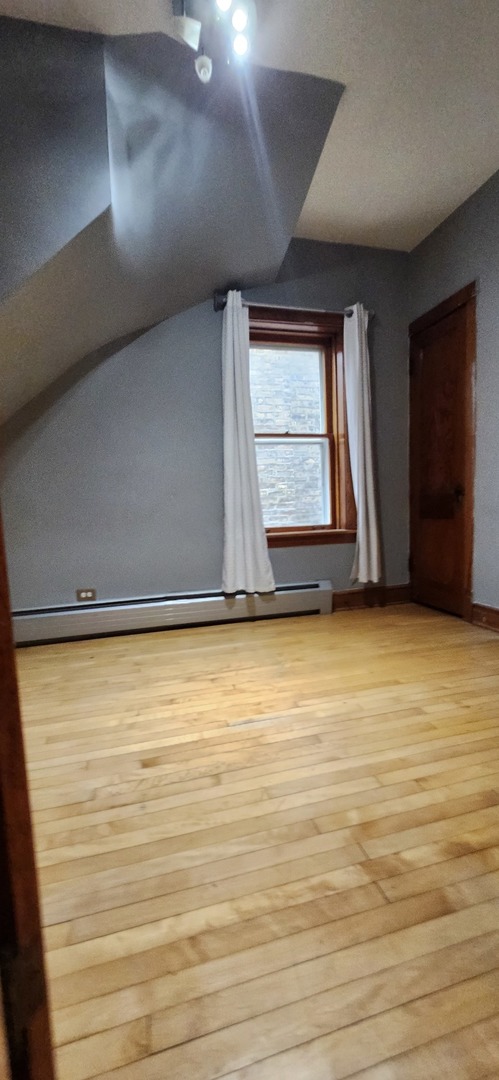 4450 West Altgeld Street, Unit 1 Chicago, IL 60639 - Photo 7 of 29 a view of an empty room with a window