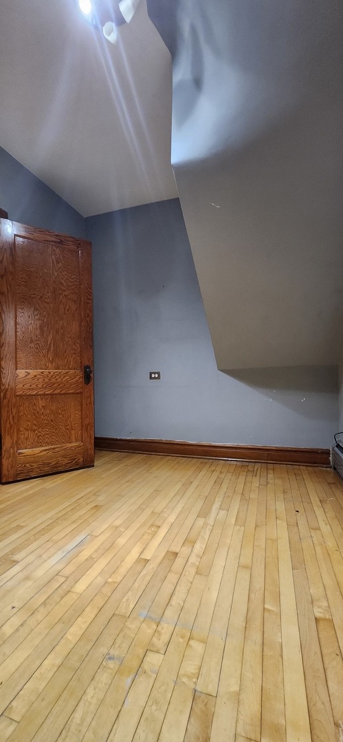 4450 West Altgeld Street, Unit 1 Chicago, IL 60639 - Photo 8 of 29 a view of an empty room with wooden floor