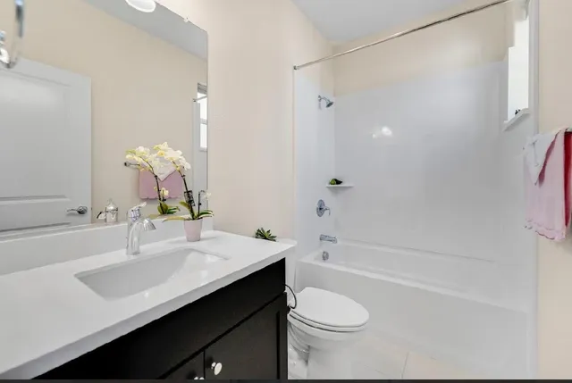 a view of a kitchen with a sink and stainless steel appliances