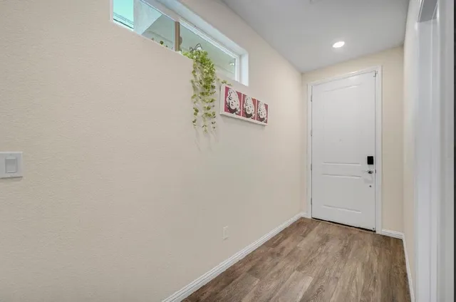 a large white kitchen with stainless steel appliances a refrigerator and a stove top oven
