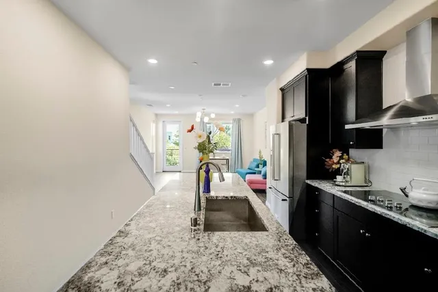 a kitchen with a stove and a wooden floor