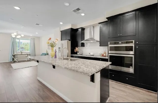 a kitchen with granite countertop a sink and cabinets