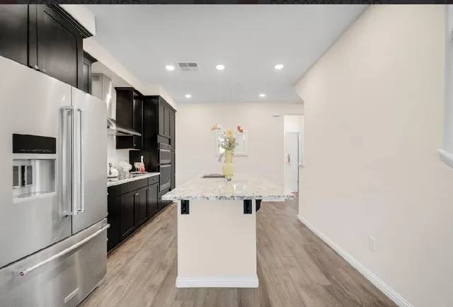 a living room with furniture potted plant and a chandelier
