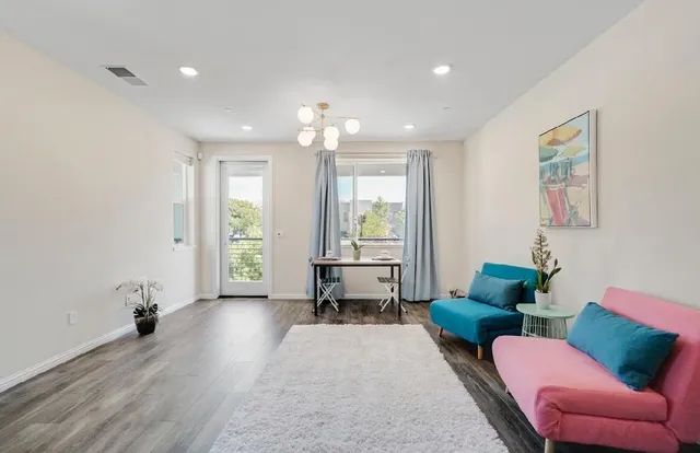 a living room with furniture and wooden floor
