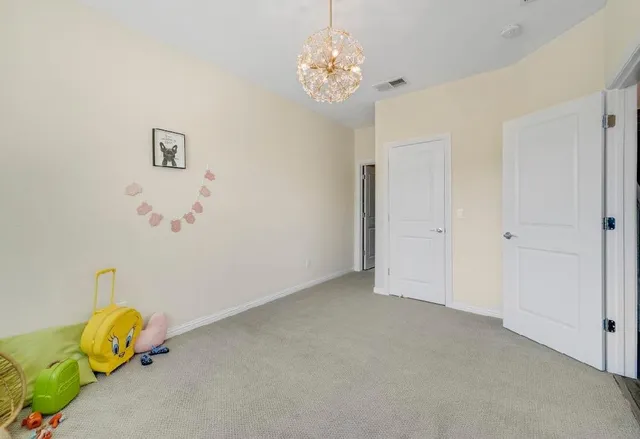 a bathroom with a window and a chandelier