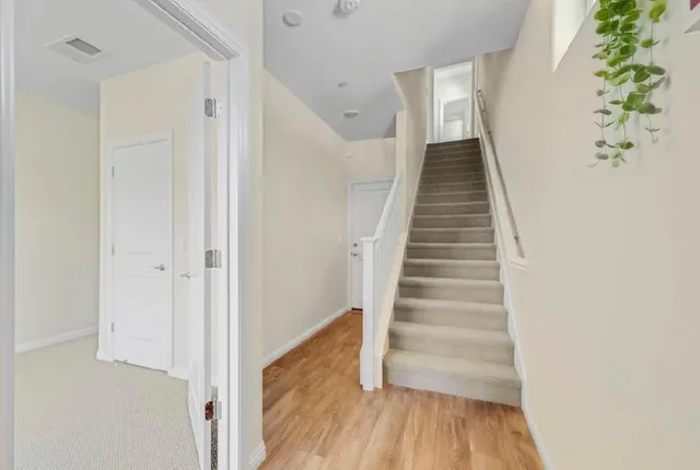 a bathroom with a sink a toilet a mirror a vanity and bathtub