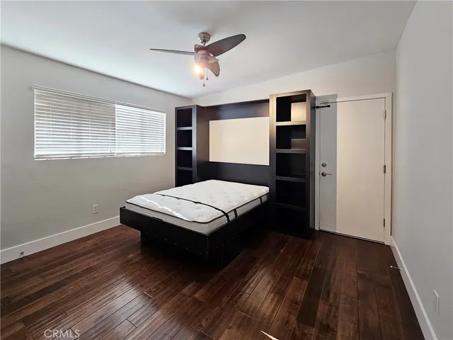 a bedroom with a bed and a bookshelf